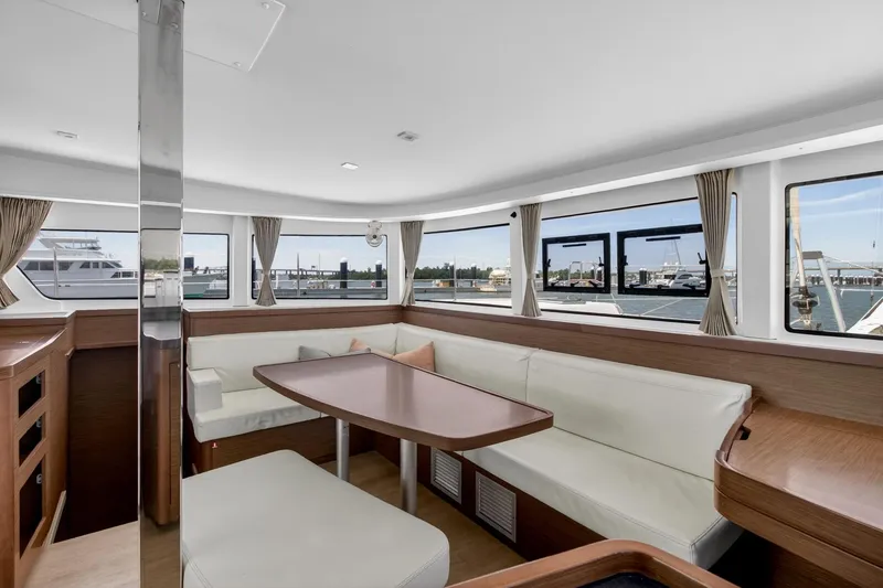 Slide: The Image of Interior of 2018 Lagoon 42 catamaran with spacious seating and panoramic windows. - 30