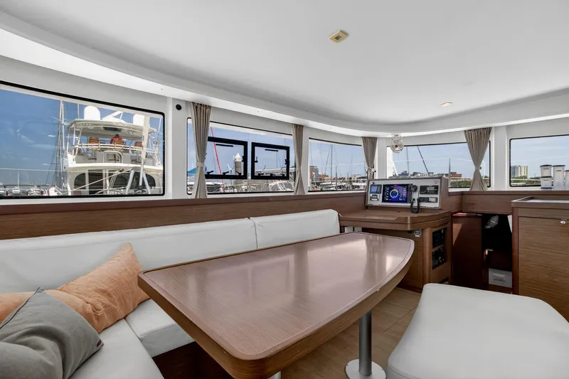 Slide: The Image of Interior of 2018 Lagoon 42 catamaran with modern seating and navigation equipment. - 34