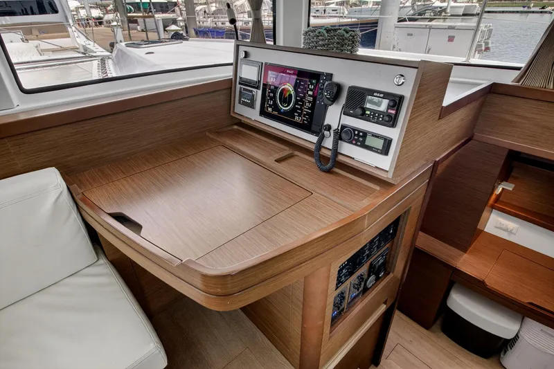 Slide: The Image of Interior of 2018 Lagoon 42 yacht with navigation equipment and wooden finish. - 35