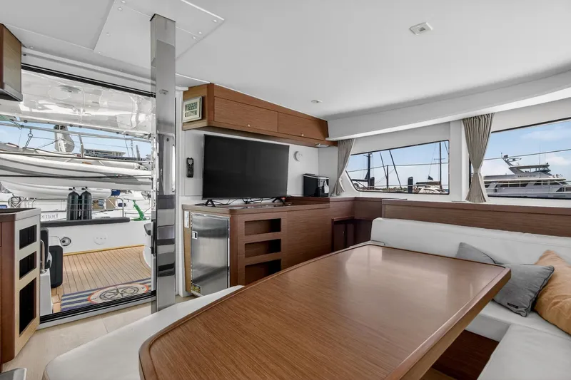 Slide: The Image of Interior of 2018 Lagoon 42 yacht with modern furnishings and marina view. - 36