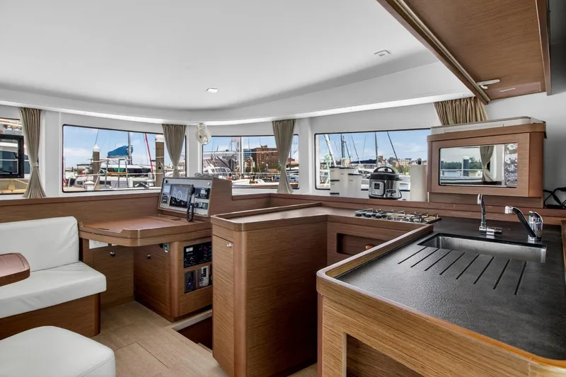 Slide: The Image of Interior of 2018 Lagoon 42 catamaran with modern kitchen and navigation area. - 37