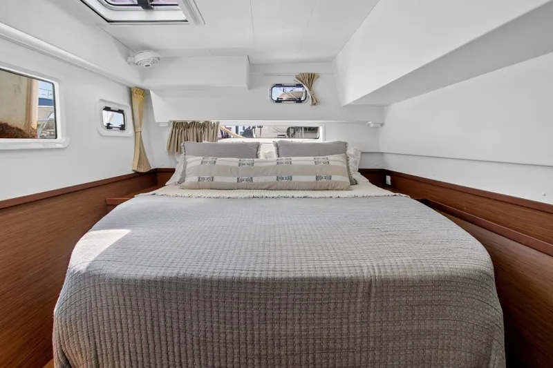 Slide: The Image of Luxurious cabin interior of 2018 Lagoon 42 catamaran with cozy bedding and natural light. - 42