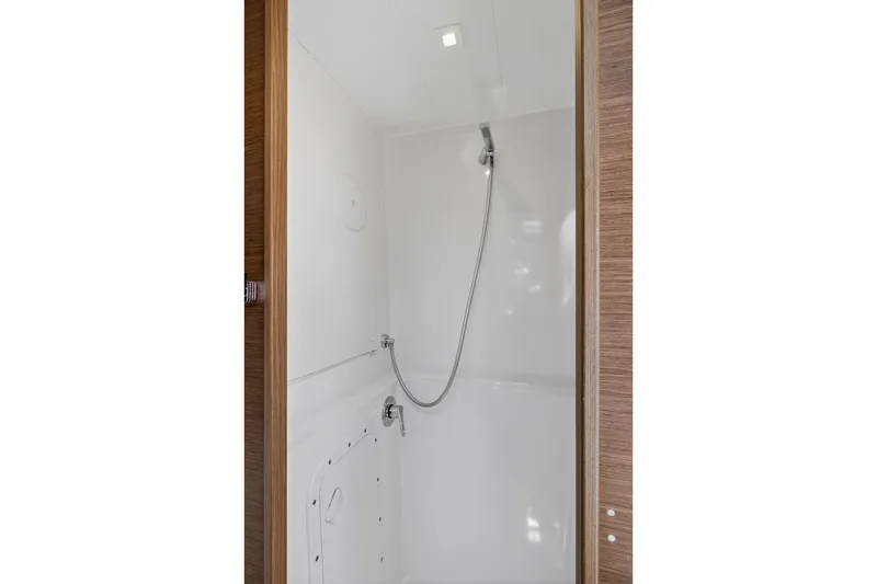 Slide: The Image of Shower area inside 2018 Lagoon 42 yacht, featuring sleek white design and modern fixtures. - 46