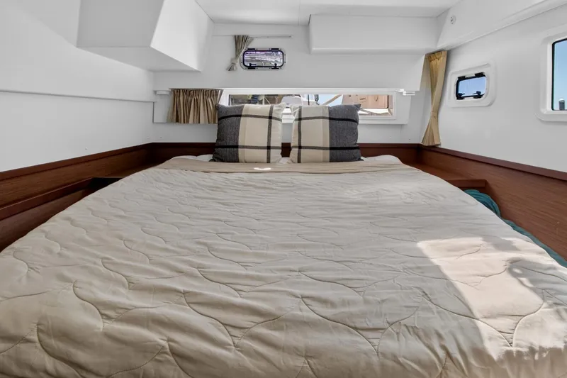 Slide: The Image of Cozy bedroom interior of 2018 Lagoon 42 catamaran with plush bedding and natural light. - 47