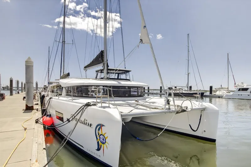 Slide: The Image of 2018 Lagoon 42 catamaran docked at marina under clear sky. - 5