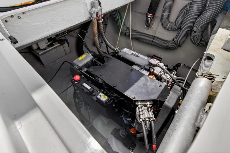 Slide: The Image of Engine compartment of a 2018 Lagoon 42 catamaran, showcasing mechanical components and wiring. - 55