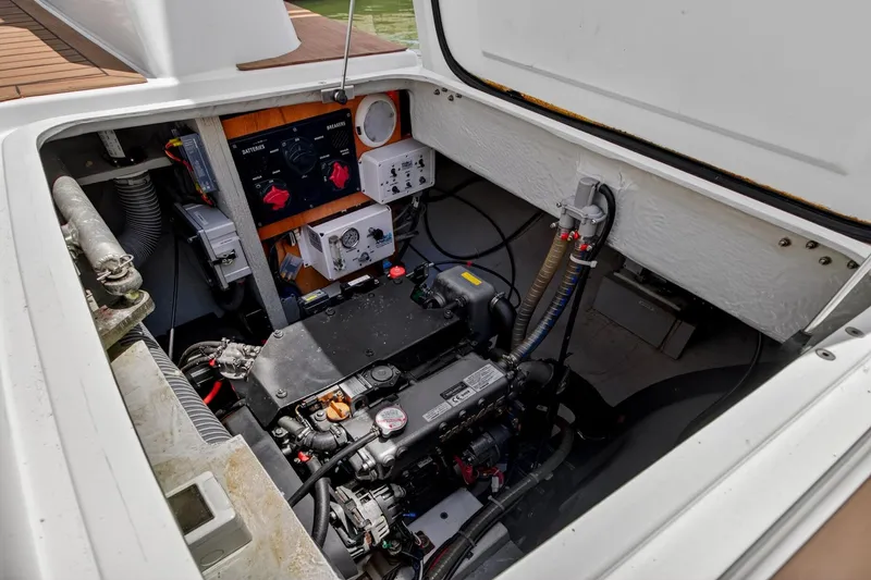 Slide: The Image of Engine compartment of a 2018 Lagoon 42 catamaran, showcasing mechanical components and wiring. - 56
