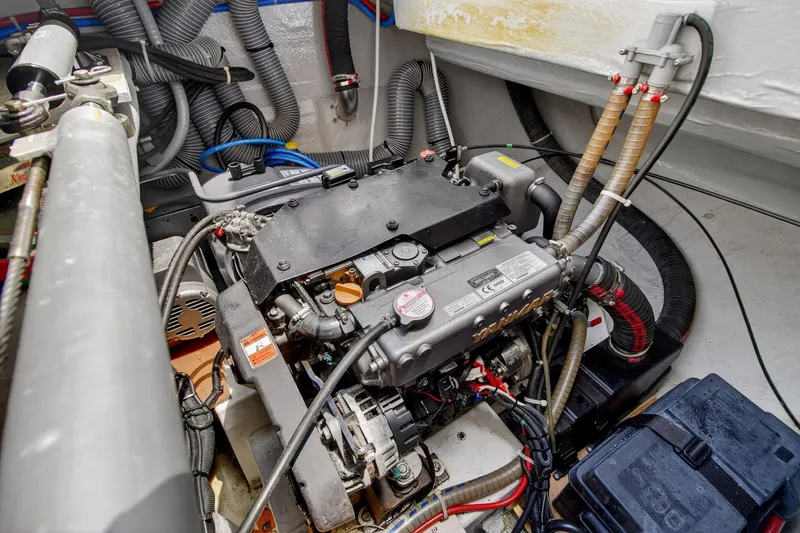 Slide: The Image of Engine compartment of a 2018 Lagoon 42 catamaran, showcasing mechanical components and wiring. - 57