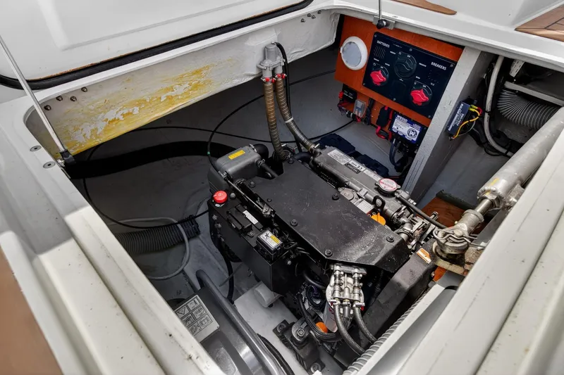 Slide: The Image of Engine compartment of a 2018 Lagoon 42 catamaran, showcasing mechanical components and control panel. - 58