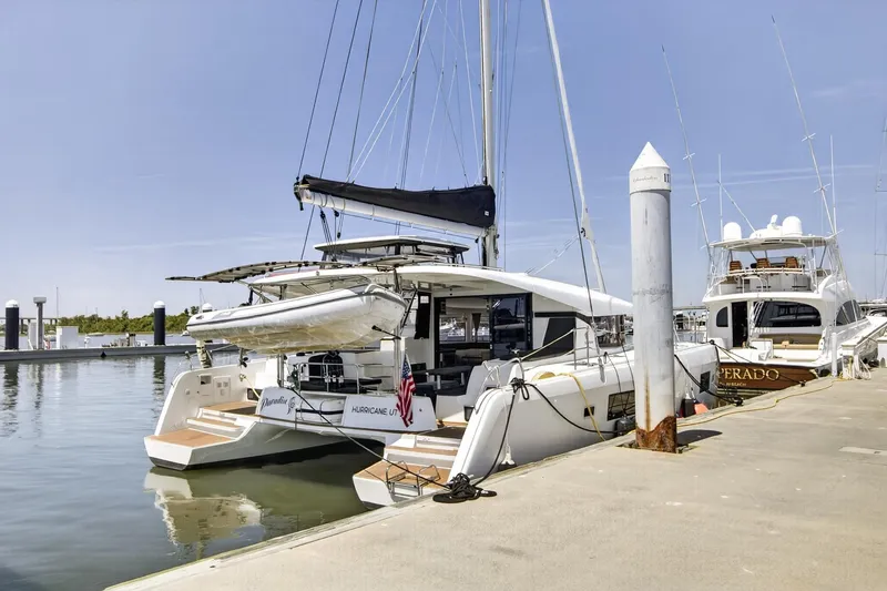 Slide: The Image of 2018 Lagoon 42 catamaran docked at marina, featuring sleek design and modern amenities. - 6