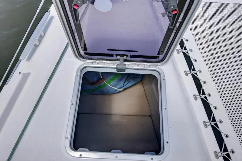 Slide: The Image of Open hatch on 2018 Lagoon 42 catamaran deck, revealing storage compartment. - 60