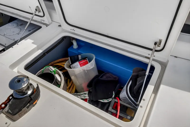 Slide: The Image of Storage compartment on a 2018 Lagoon 42 yacht, containing various boating equipment. - 61