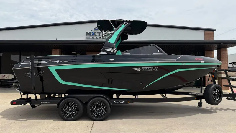 The Image of 2022 Tigé 23ZX boat on trailer in front of building. - 1