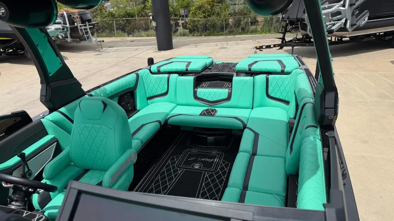 Slide: The Image of Interior of a 2022 Tigé 23ZX boat with turquoise seating. - 12