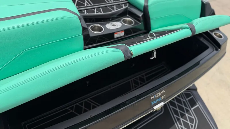 Slide: The Image of Interior of 2022 Tigé 23ZX with green seats and storage area. - 22