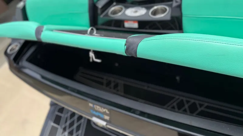 Slide: The Image of Interior of a 2022 Tigé 23ZX boat with green upholstery. - 23