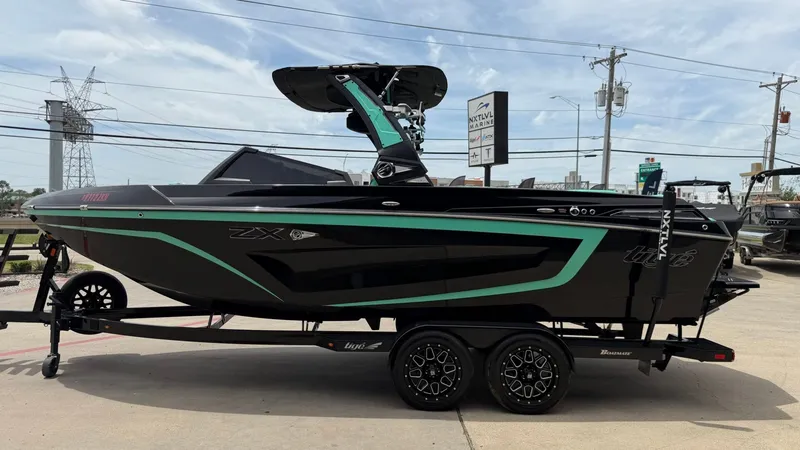 Slide: The Image of 2022 Tigé 23ZX boat on trailer, side view. - 6