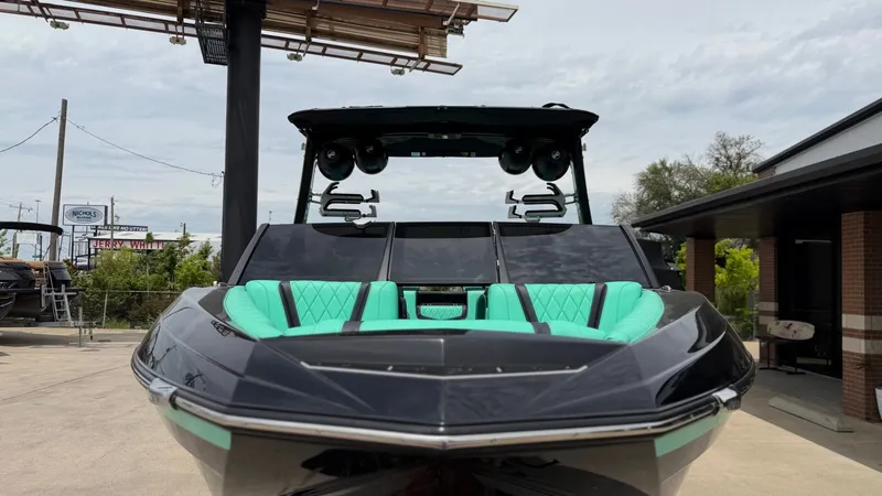 Slide: The Image of 2022 Tigé 23ZX boat with turquoise seats, front view. - 8