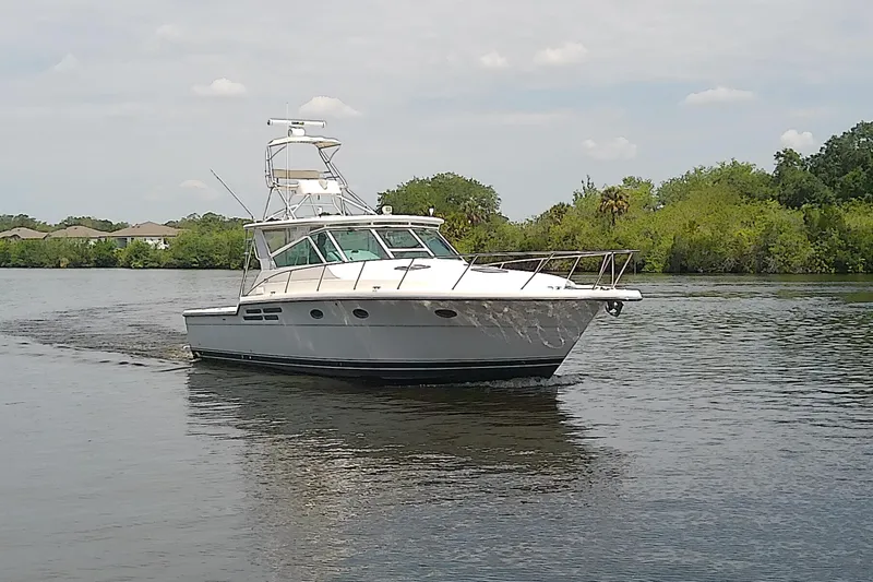 The Image of 2000 Tiara Yachts 4100 Open cruising on a calm river with lush greenery. - 0
