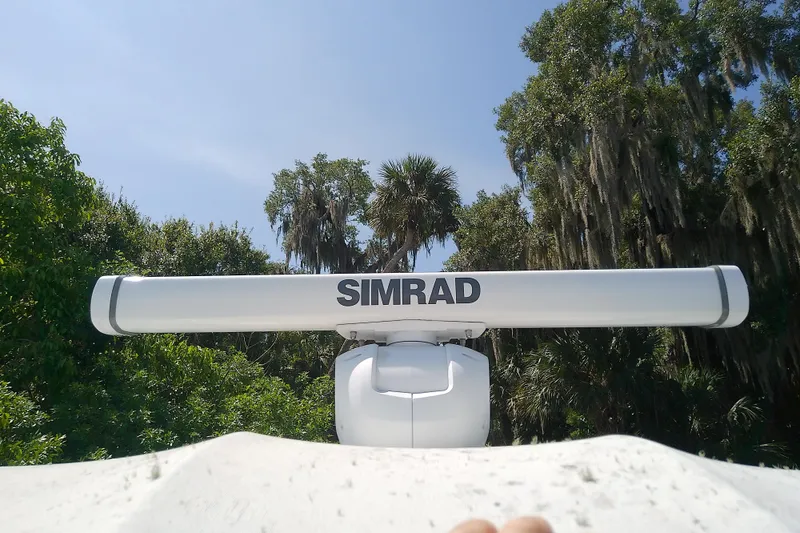 Slide: The Image of Simrad radar on 2000 Tiara Yachts 4100 Open, surrounded by lush greenery. - 24