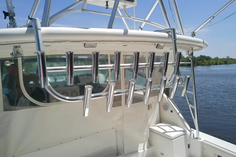 Slide: The Image of Tiara Yachts 4100 Open 2000 model with rod holders on a sunny day by the water. - 25
