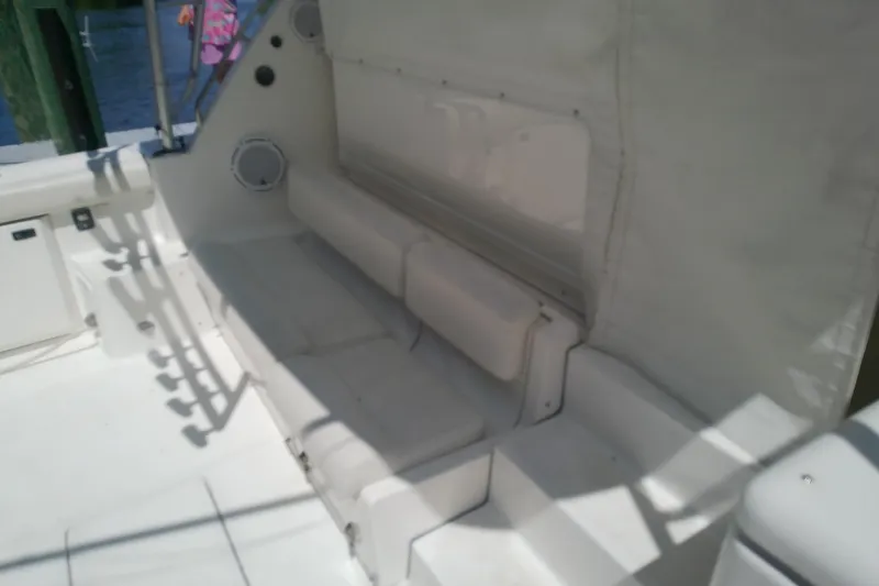 Slide: The Image of Interior seating area of a 2000 Tiara Yachts 4100 Open, featuring white cushioned benches. - 27