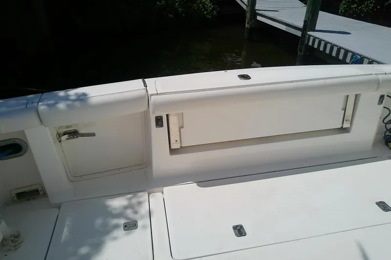 Slide: The Image of 2000 Tiara Yachts 4100 Open boat deck with storage compartments and dock view. - 29