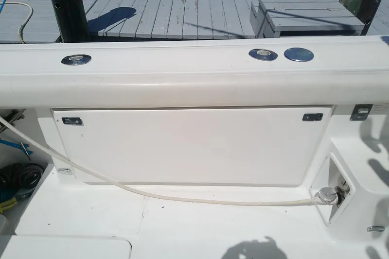 Slide: The Image of 2000 Tiara Yachts 4100 Open deck detail with storage compartment and utility connections. - 31