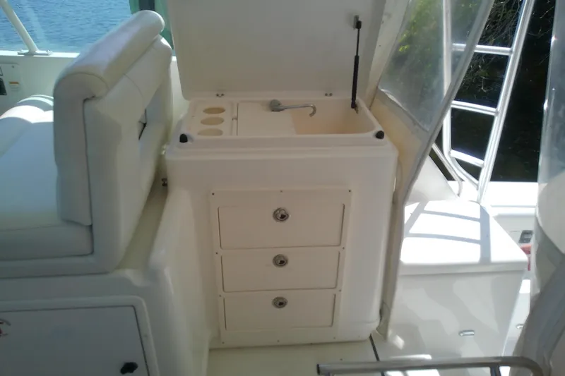 Slide: The Image of Interior view of a 2000 Tiara Yachts 4100 Open, featuring a compact sink and storage drawers. - 35