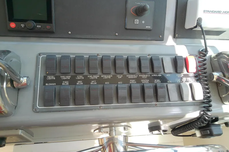 Slide: The Image of Control panel of a 2000 Tiara Yachts 4100 Open with labeled switches and controls. - 42