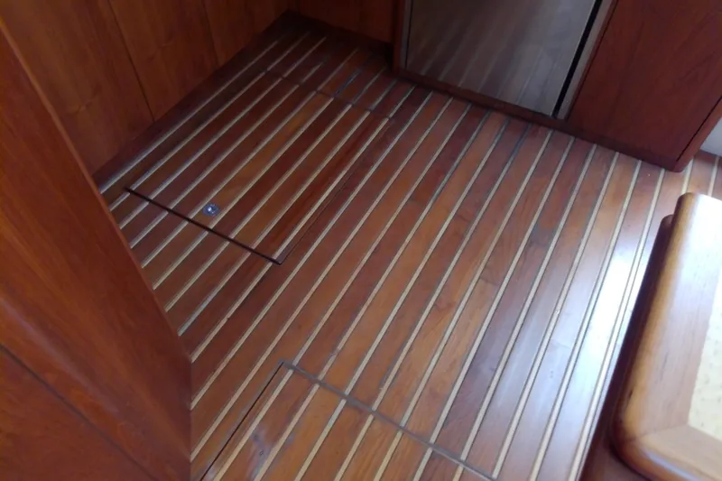 Slide: The Image of Teak flooring inside a 2000 Tiara Yachts 4100 Open, showcasing elegant wood finish. - 48
