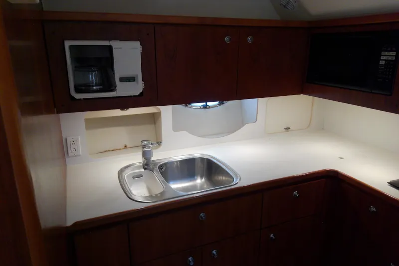 Slide: The Image of 2000 Tiara Yachts 4100 Open galley with sink, microwave, and coffee maker. - 52