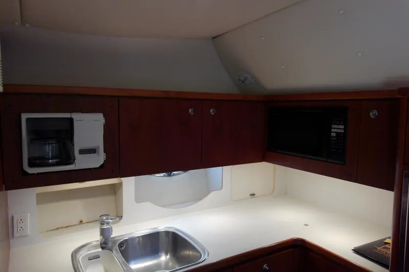 Slide: The Image of Kitchen area of a 2000 Tiara Yachts 4100 Open with sink, microwave, and coffee maker. - 53