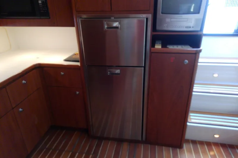 Slide: The Image of Kitchen area of a 2000 Tiara Yachts 4100 Open with stainless steel appliances. - 56