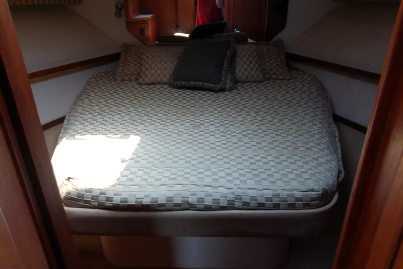 Slide: The Image of Interior cabin of 2000 Tiara Yachts 4100 Open with a cozy bed setup. - 58