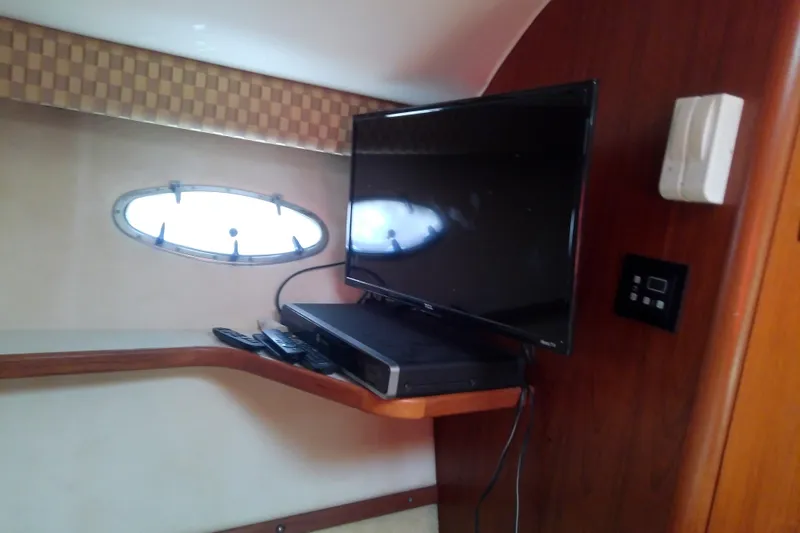 Slide: The Image of Interior of 2000 Tiara Yachts 4100 Open with TV and porthole window. - 61