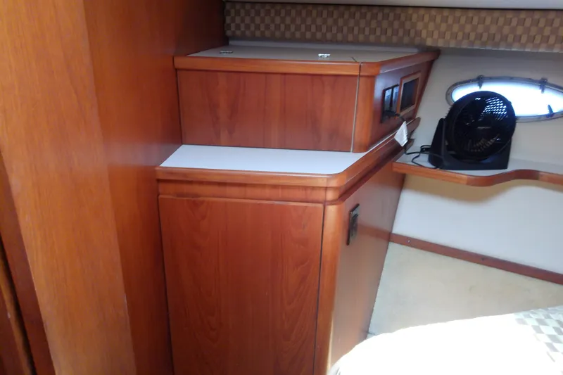 Slide: The Image of Interior of 2000 Tiara Yachts 4100 Open with wooden cabinetry and small fan. - 62