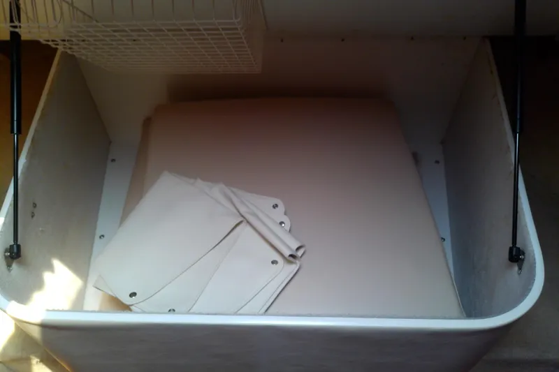 Slide: The Image of Storage compartment in a 2000 Tiara Yachts 4100 Open, featuring folded canvas covers. - 64