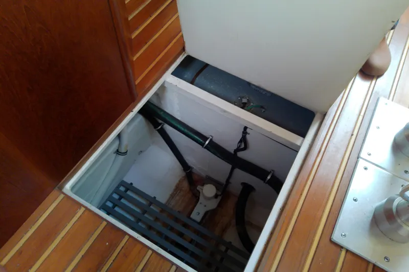 Slide: The Image of Bilge compartment of 2000 Tiara Yachts 4100 Open, showcasing plumbing and storage. - 69