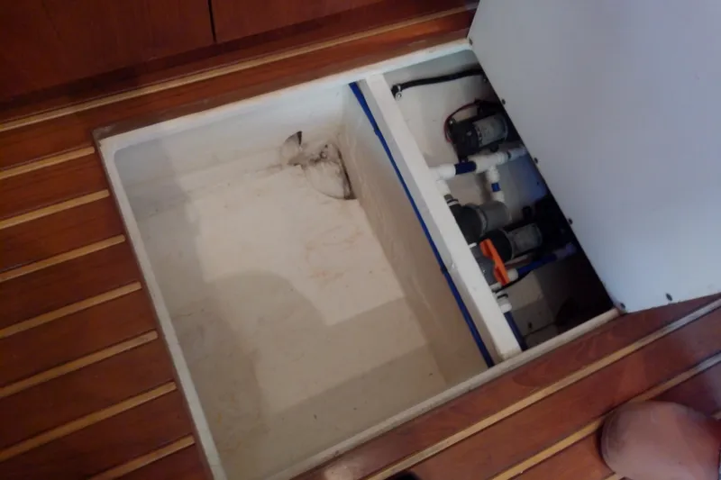 Slide: The Image of Bilge compartment of 2000 Tiara Yachts 4100 Open, showcasing pumps and wooden flooring. - 70