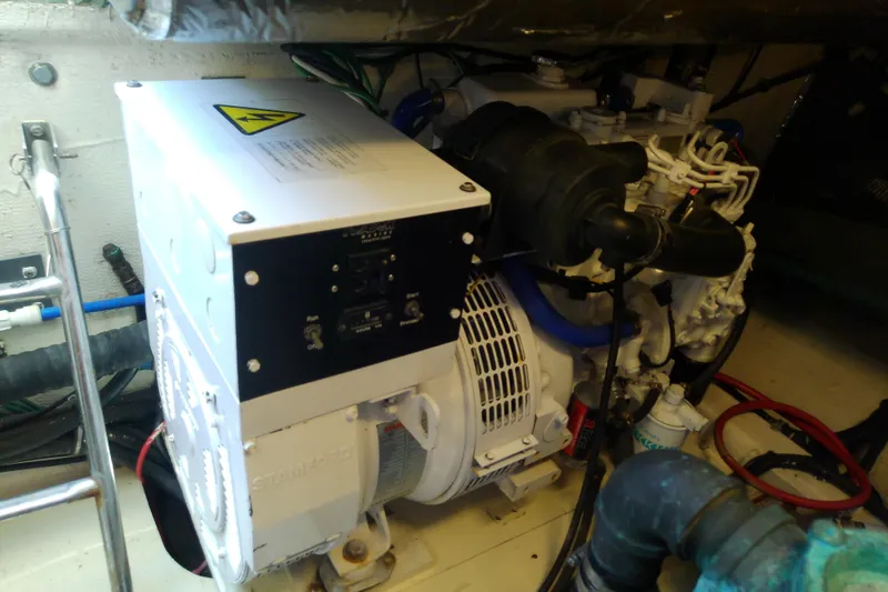Slide: The Image of Engine room of 2000 Tiara Yachts 4100 Open, featuring generator and wiring. - 72