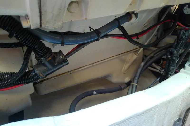 Slide: The Image of Engine compartment of a 2000 Tiara Yachts 4100 Open, showing wiring and hoses. - 76