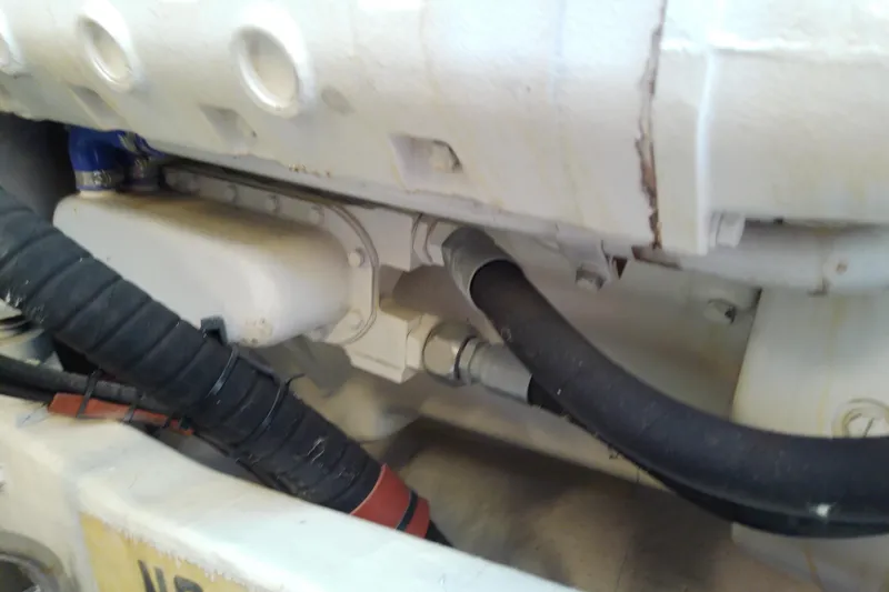 Slide: The Image of Engine compartment of a 2000 Tiara Yachts 4100 Open, showing hoses and components. - 77