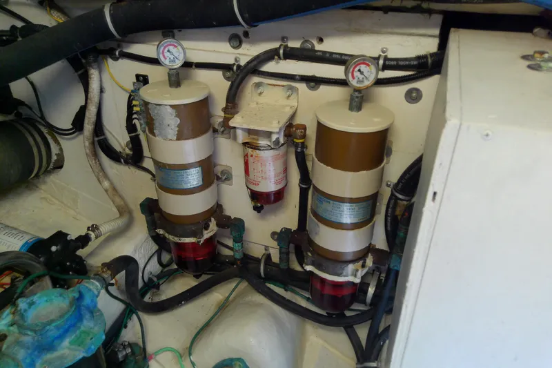 Slide: The Image of Engine room of 2000 Tiara Yachts 4100 Open, featuring fuel filters and gauges. - 78