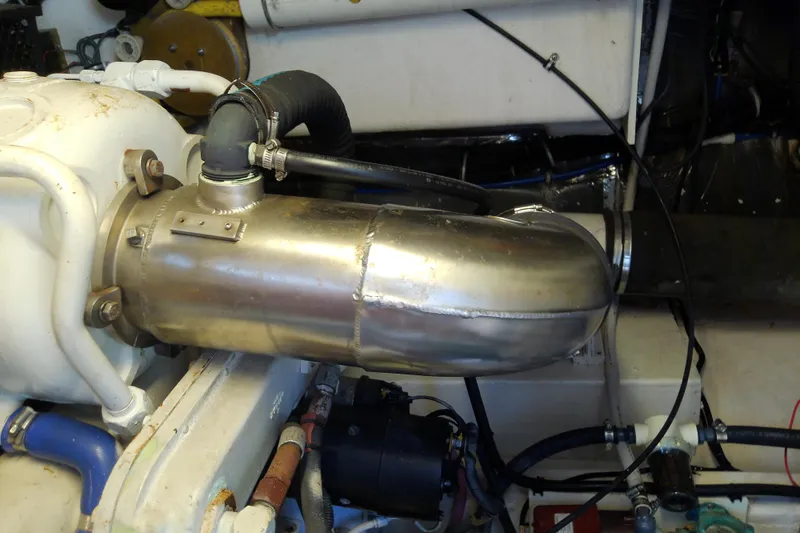 Slide: The Image of Engine compartment of a 2000 Tiara Yachts 4100 Open, featuring metal exhaust components. - 79