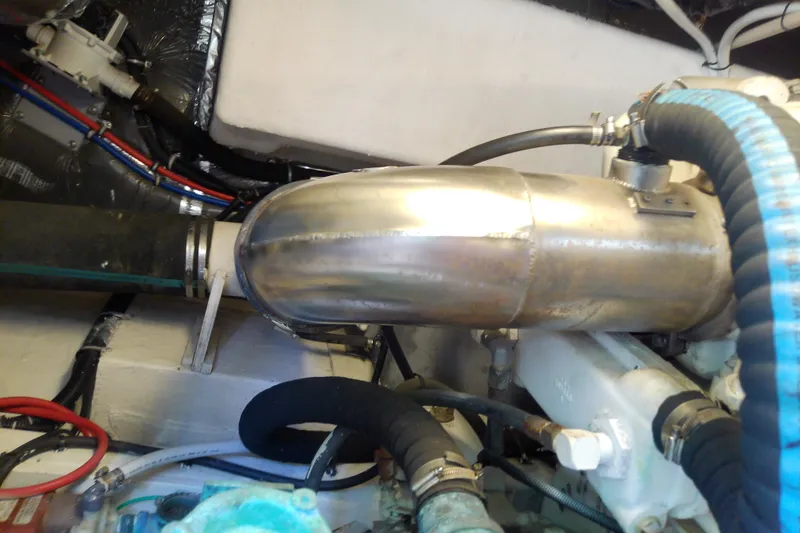 Slide: The Image of Engine compartment of a 2000 Tiara Yachts 4100 Open, showcasing exhaust system components. - 80