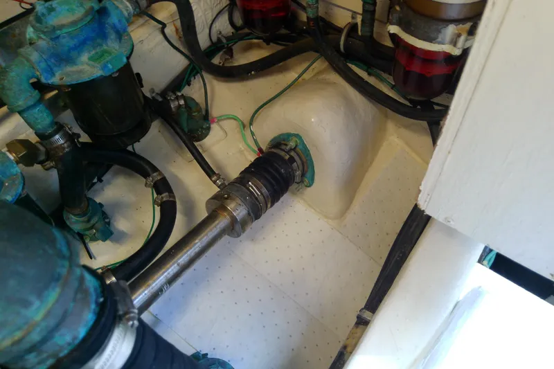 Slide: The Image of Engine compartment of a 2000 Tiara Yachts 4100 Open, showing mechanical components and hoses. - 81