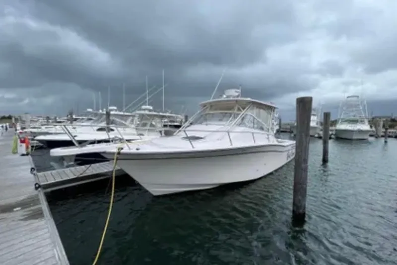 Slide: The Image of 2007 Grady-White Express 330 boat docked at marina under cloudy skies. - 10