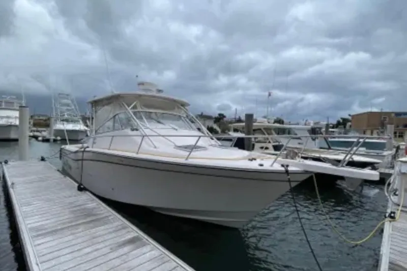 Slide: The Image of 2007 Grady-White Express 330 boat docked at marina under cloudy sky. - 11