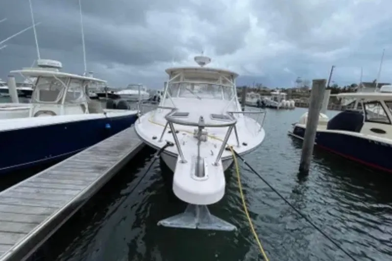 Slide: The Image of 2007 Grady-White Express 330 boat docked at marina under cloudy skies. - 13